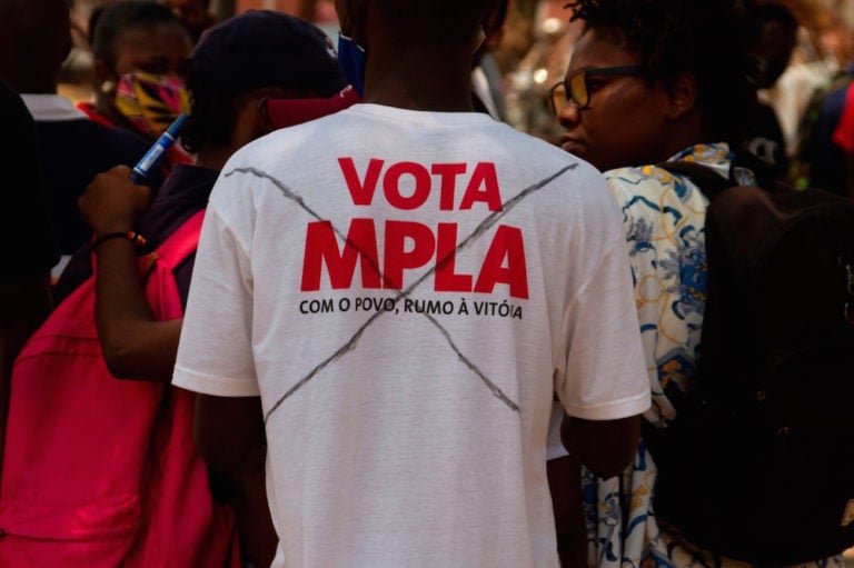 A protester wears a t-shirt with an X over a slogan that reads "Vote MPLA" during a demonstration against corruption, in Luanda, Angola, 3 October 2020, OSVALDO SILVA/AFP via Getty Images