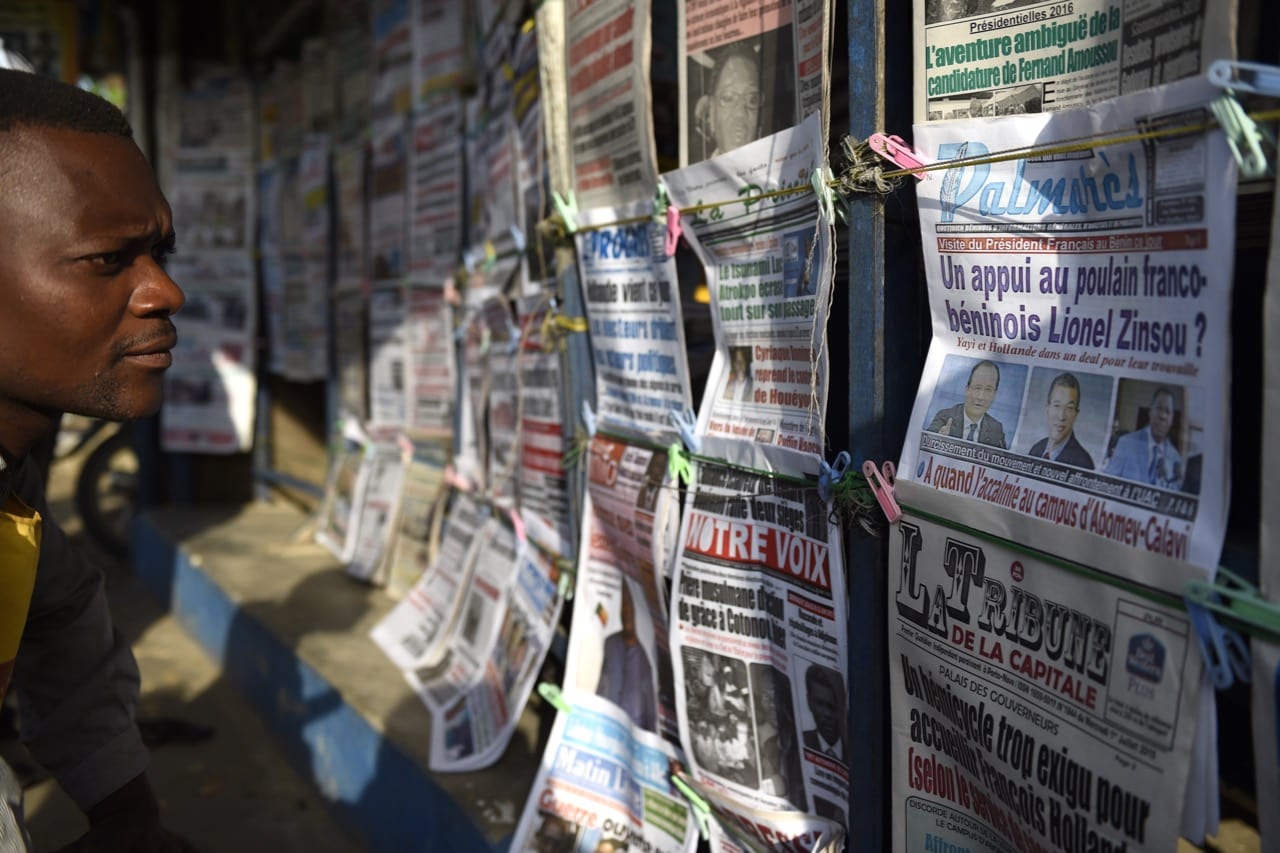 A man reads newspaper headlines in the streets of Cotonou, Benin, on 1 July 2015, ALAIN JOCARD/AFP/Getty Images