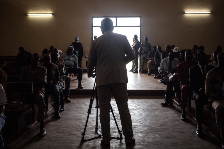 A journalist films at the Constitutional Court in Bangui, Central African Republic, 18 January 2021, during the announcement of the results of the presidential elections, FLORENT VERGNES/AFP via Getty Images