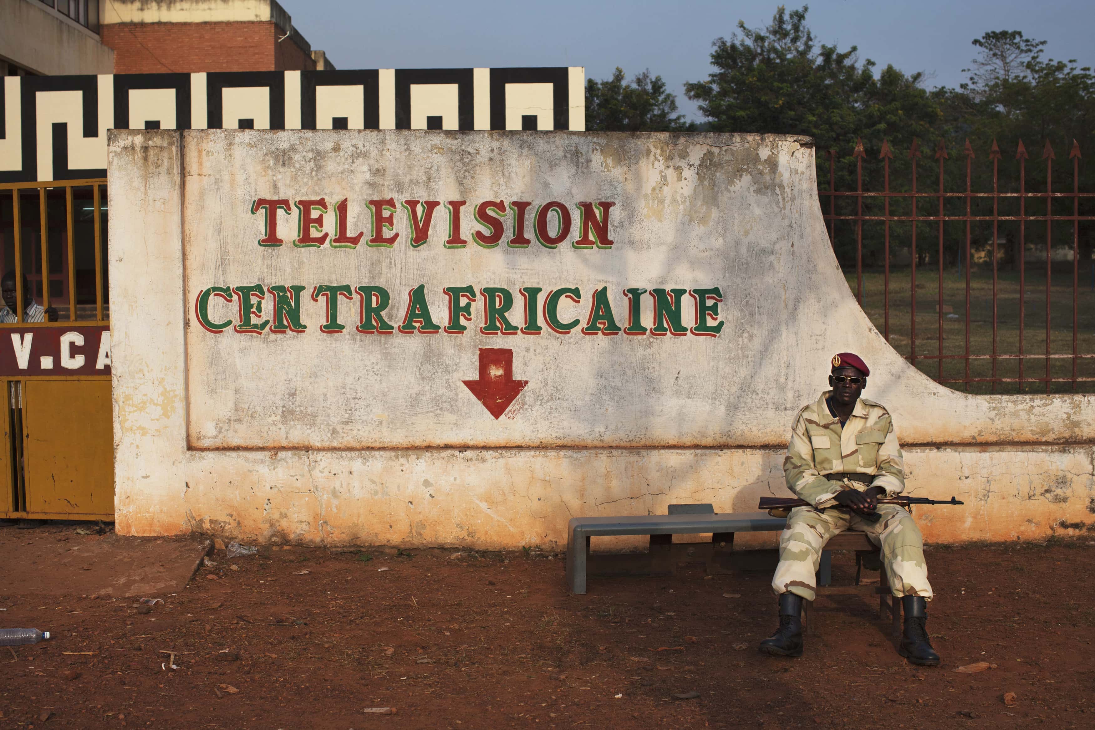 A soldier guards the entrance of the currently defunct national television headquarters in Bangui, Central African Republic 27 November 2013., REUTERS/Joe Penney
