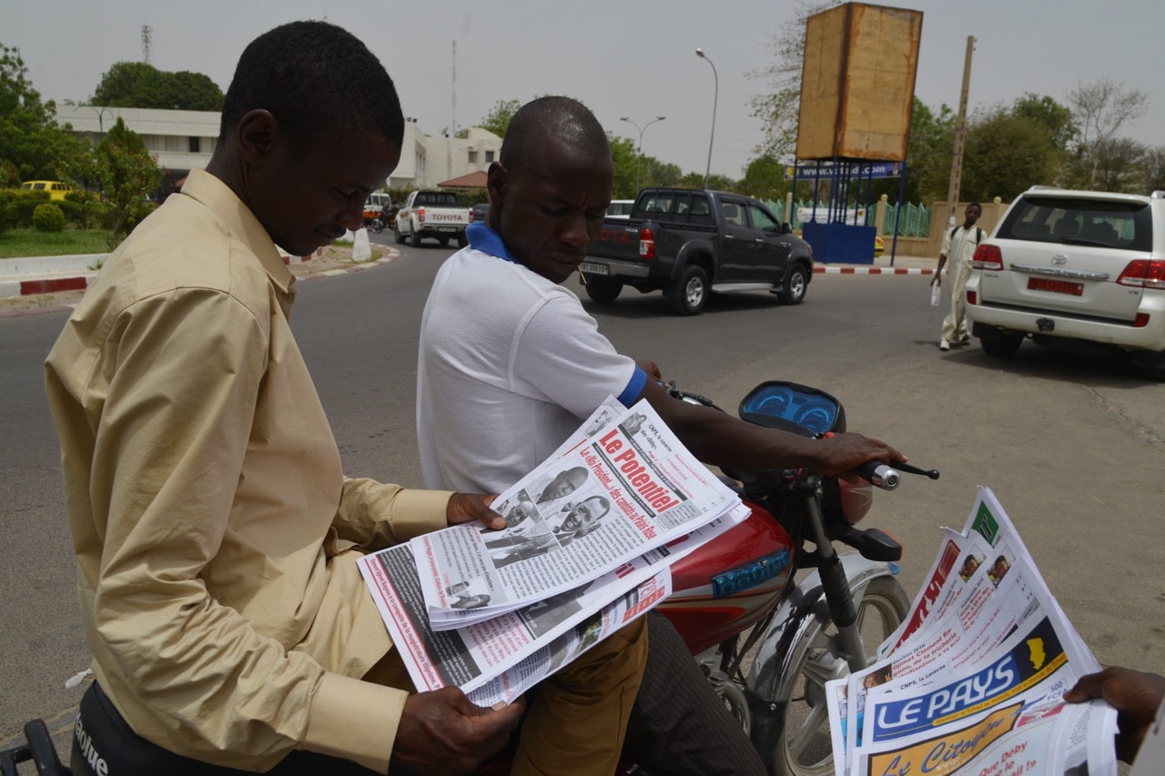 A man reads a newspaper in the street in N'Djamena, Chad, 12 April 2016, ISSOUF SANOGO/AFP/Getty Images