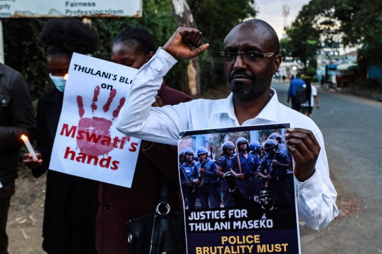 Activists hold posters and chant to pay tribute to the assassinated Human Rights Lawyer Thulani Maseko
