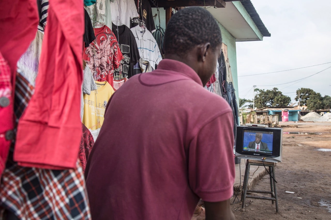 A man watches a televised political debate in Port-Gentil, Gabon, 22 August 2016, SAMIR TOUNSI/AFP/Getty Images