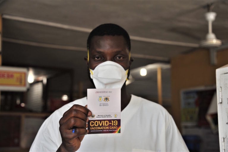 A man shows his COVID-19 vaccination card after receiving the injection at a hospital in Accra, Ghana, 2 March 2021, Xinhua/Seth via Getty Images