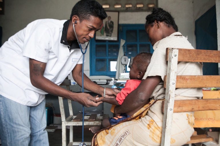 A doctor examines a malnourished child during an extended drought, at the health center in the village of Imongy, Tsihombe, southern Madagascar, 4 March 2015, RIJASOLO/AFP via Getty Images