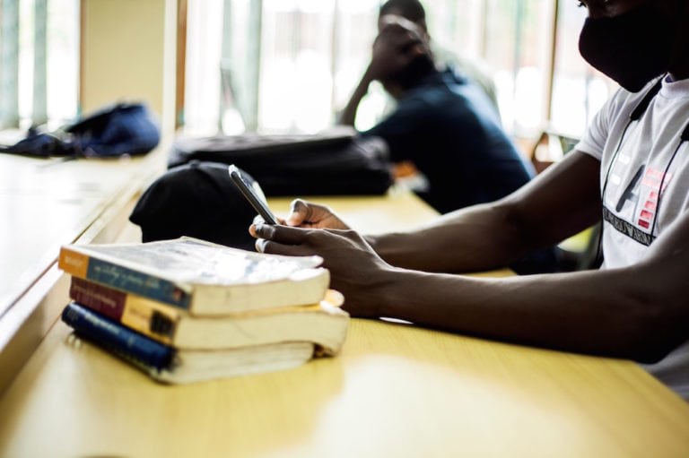 A student follows a lesson through a smartphone during the Covid-19 pandemic, in Blantyre, Malawi, 13 January 2021, Xinhua/Joseph Mizere via Getty Images