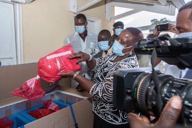 Malawi's Health Minister Khumbize Kandodo Chiponda (C) shows the press a pack of expired Covid-19 vaccines, at a pharmaceutical incinerator where the vaccines are to be destroyed, in Lilongwe, 19 May 2021, AMOS GUMULIRA/AFP via Getty Images