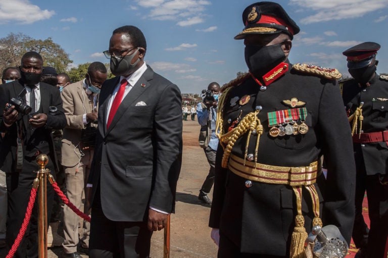 Malawi President elect Lazarus Chakwera (3rd L) is escorted to his seat after inspecting a parade during his inauguration at the Malawi Defence Force Headquarters, in Lilongwe, 6 July 2020, AMOS GUMULIRA/AFP via Getty Images
