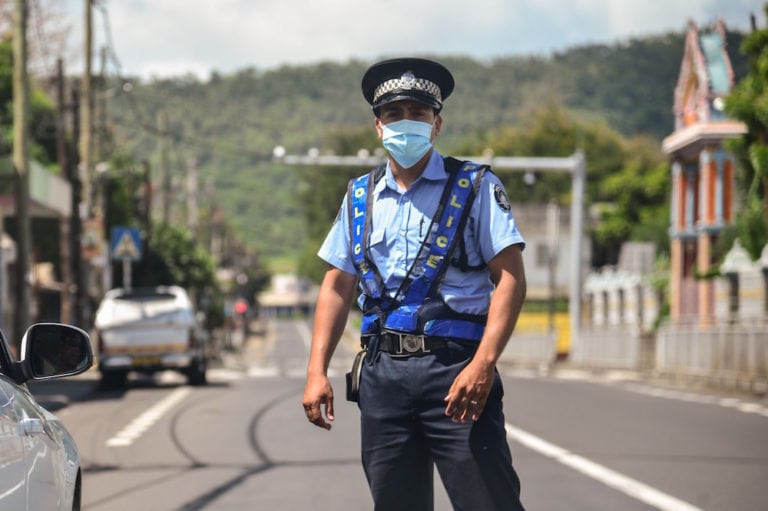 A police officer wearing a mask due to COVID-19, at a check point in the Flacq district, Mauritius, 25 March 2020, BEEKASH_ROOPUN/ l'Express Maurice / AFP/AFP via Getty Images