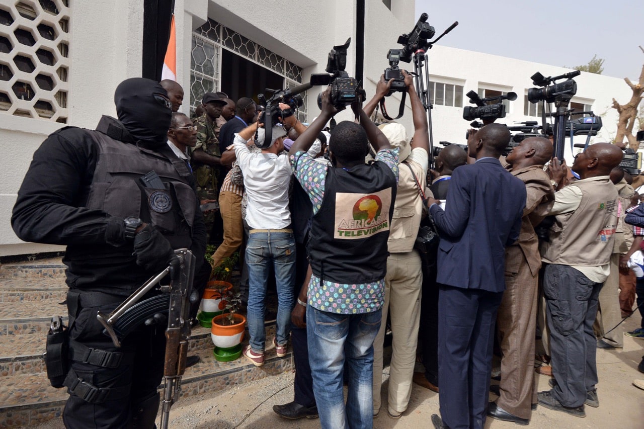 A member of Niger's special forces stands guard as journalists gather around President Mahamadou Issoufou (not seen) as he leaves the Hotel de Ville (City Hall) in Niamey, 21 February 2016, ISSOUF SANOGO/AFP/Getty Images
