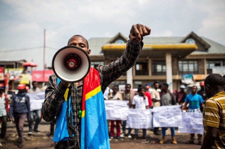 A supporter of the citizens' movement LUCHA (Struggle For Change - Lutte Pour Le Changement) speaks during a demonstration, in Goma, North Kivu, Republic of Congo, 21 December 2018, PATRICK MEINHARDT/AFP via Getty Images