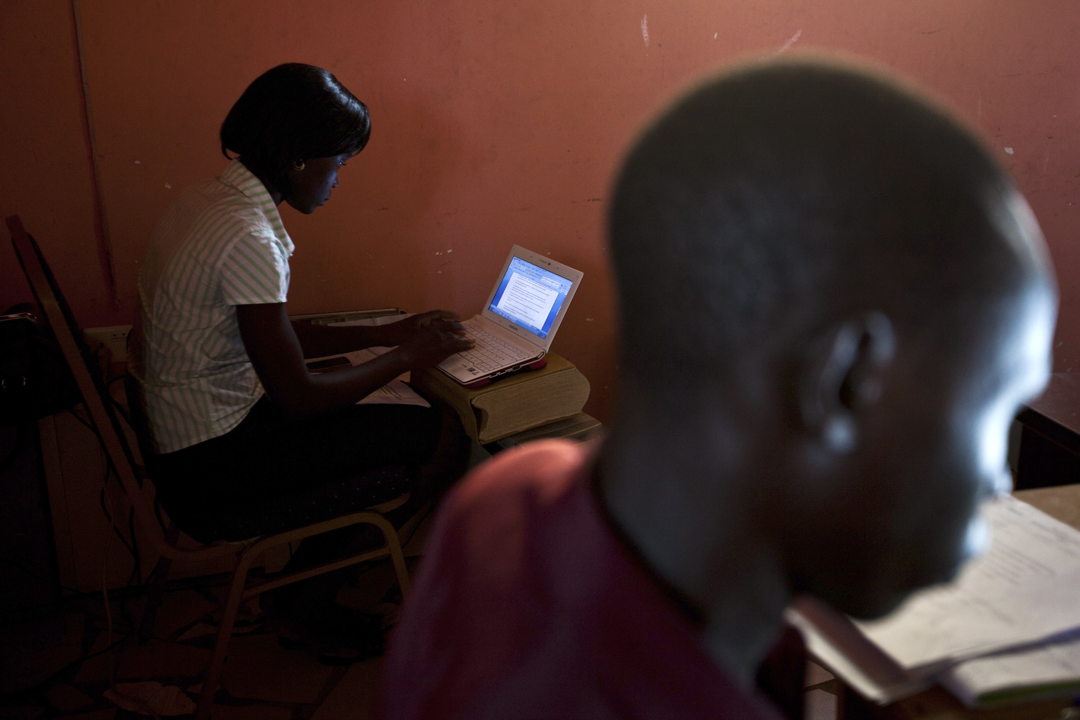 Two reporters at "The Citizen" newspaper work at their desks in Juba, South Sudan, 18 June 2012, REUTERS/Adriane Ohanesian